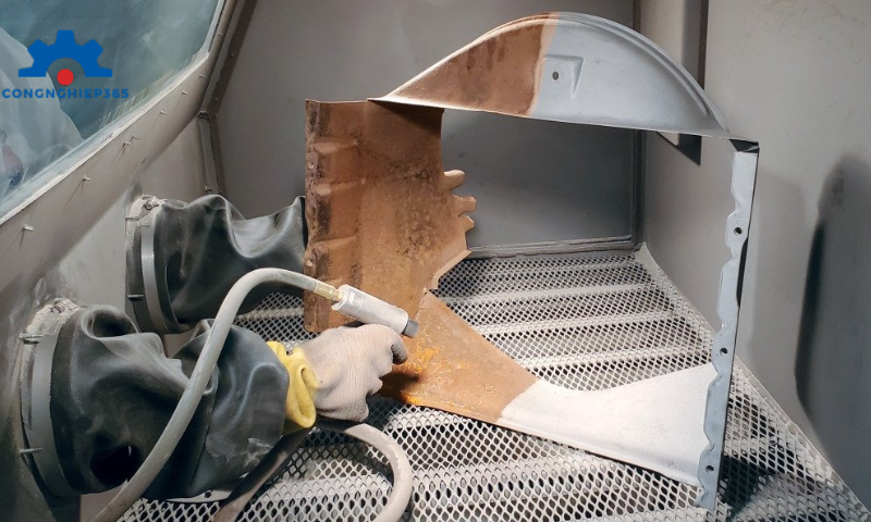 Trong ngành cơ khí, phun cát (sandblasting) là phương pháp sử dụng luồng khí nén mạnh để bắn các hạt mài lên bề mặt kim loại, giúp loại bỏ gỉ sét, sơn cũ hoặc tạp chất